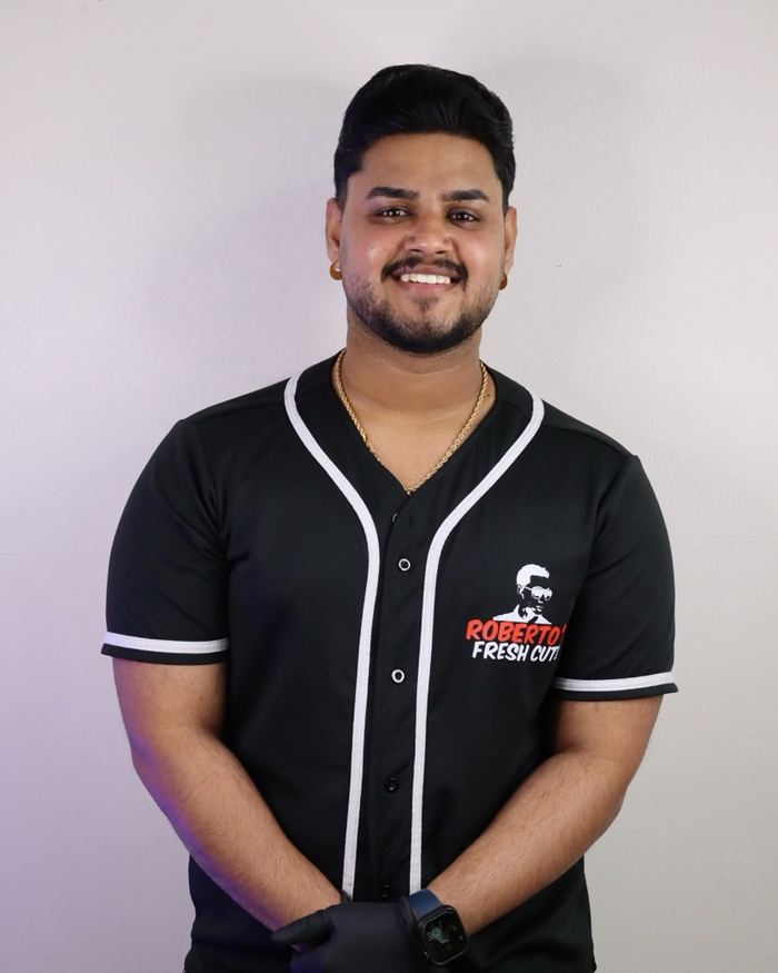 A barber on the Roberto's Fresh Cuts team